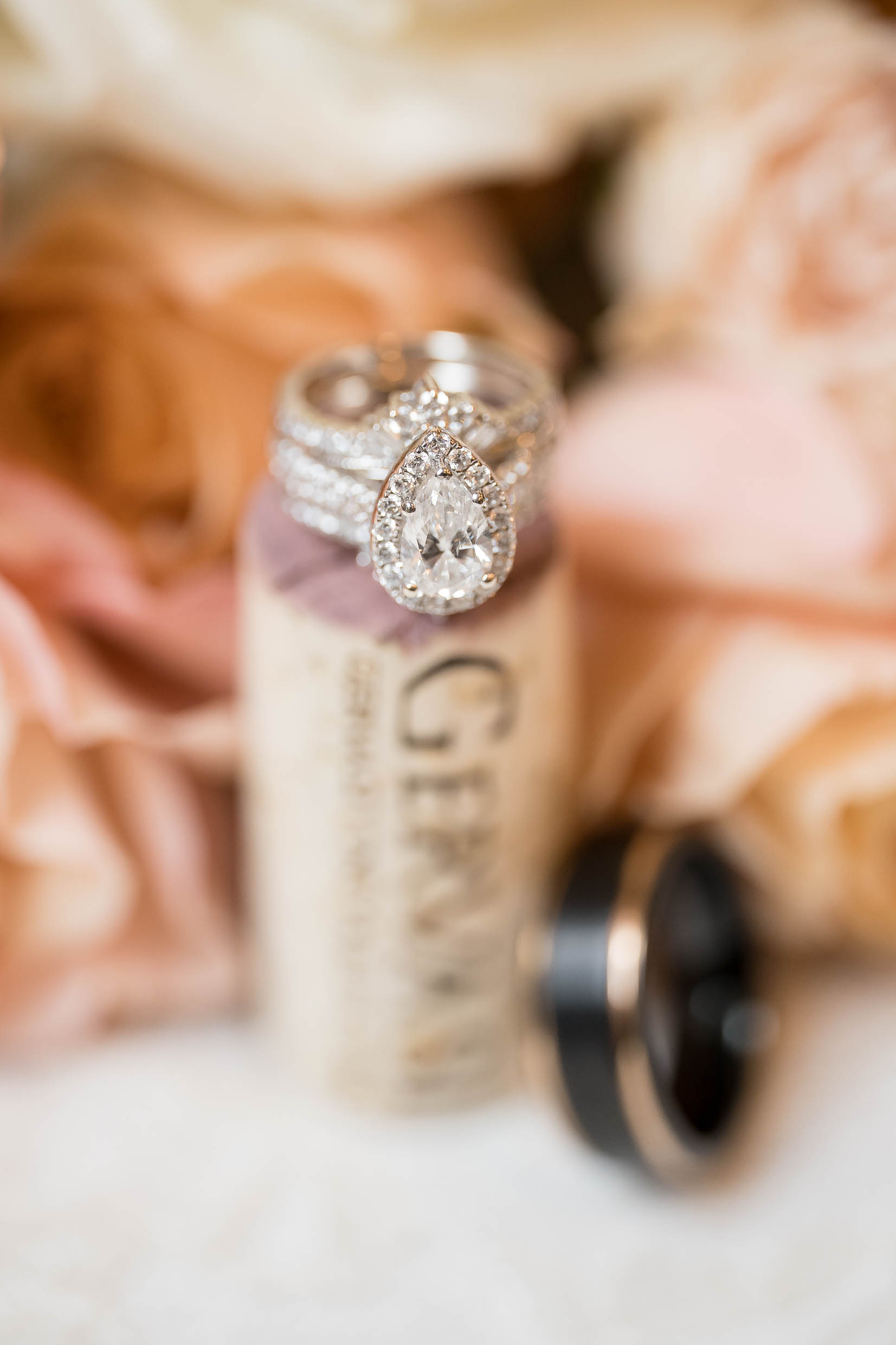 Flatlay of wedding invitations, rings, and flowers before Pavilion wedding at Gervasi Vineyard.
