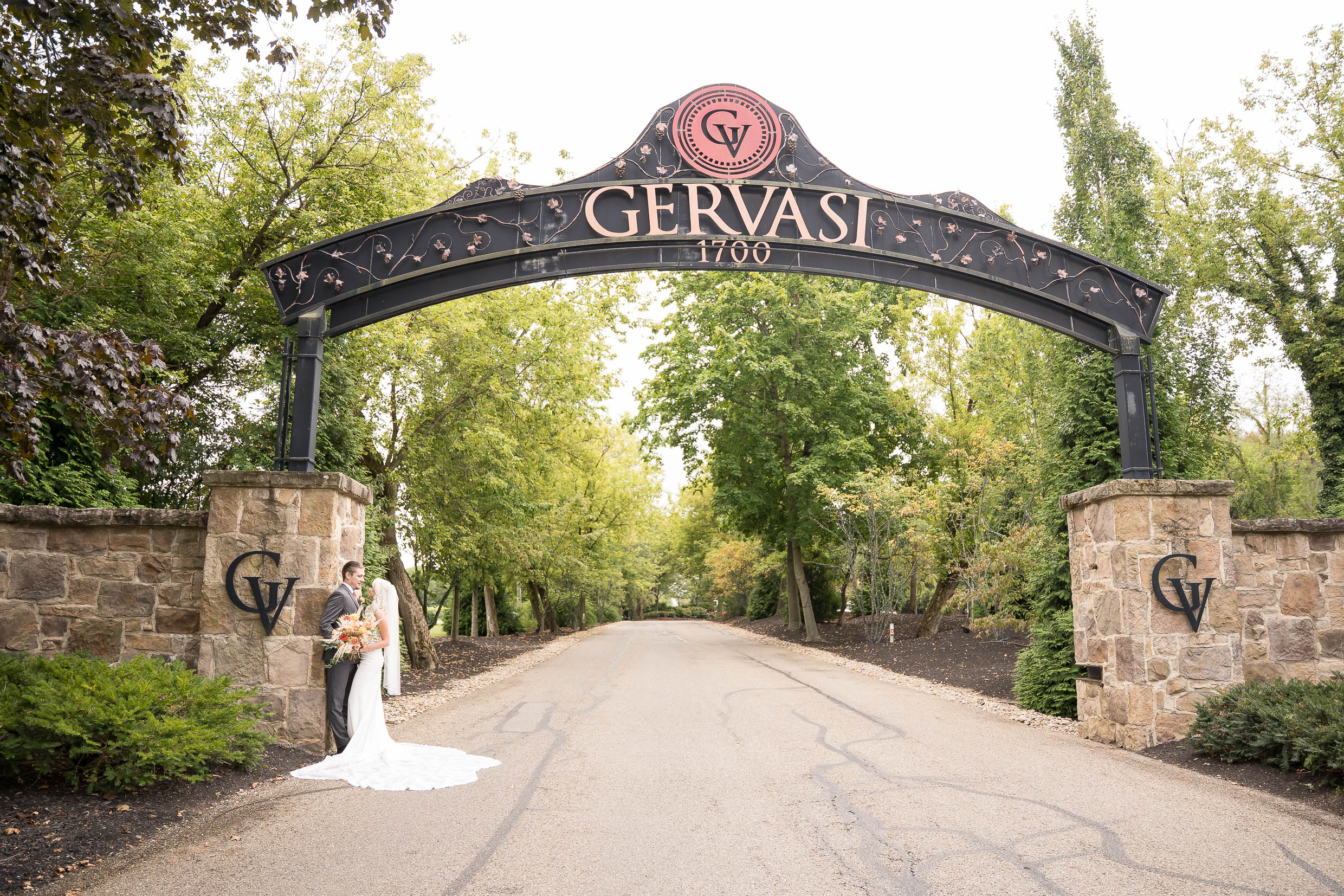 Gervasi Vineyard Wedding Photos, bride and groom at front entrance to Gervasi