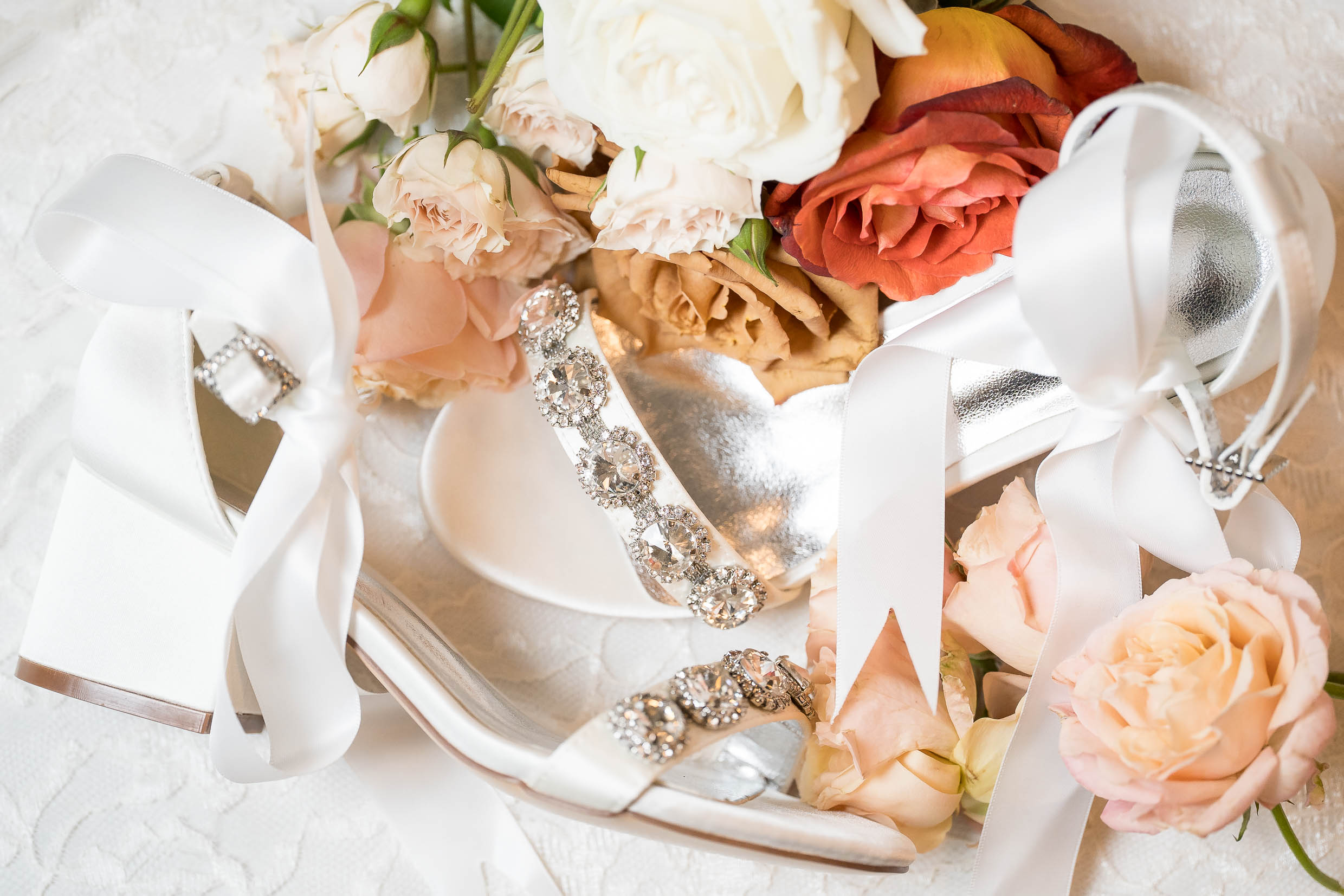 Flatlay of wedding invitations, rings, and flowers before Pavilion wedding at Gervasi Vineyard.