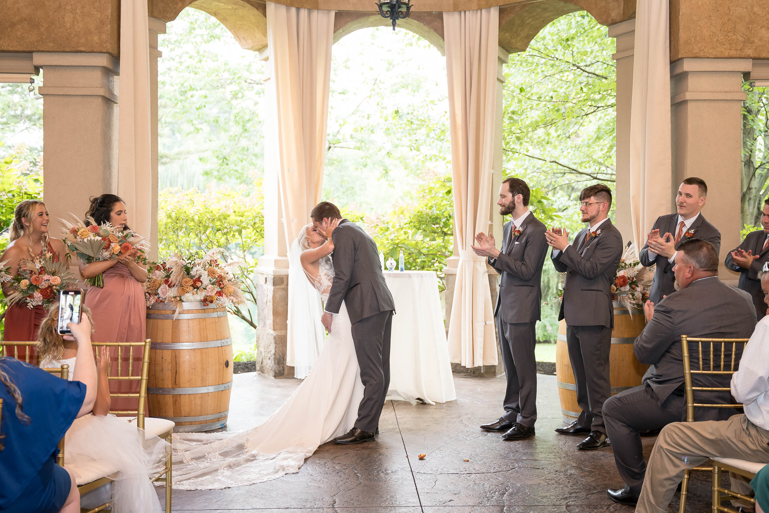 Bride and groom first kiss at Gervasi Vineyard wedding ceremony